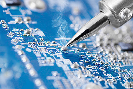 Microcircuit being fixed with soldering iron. Tech behind the biometrics credit cards. (Image Credit: SmartMetrics)