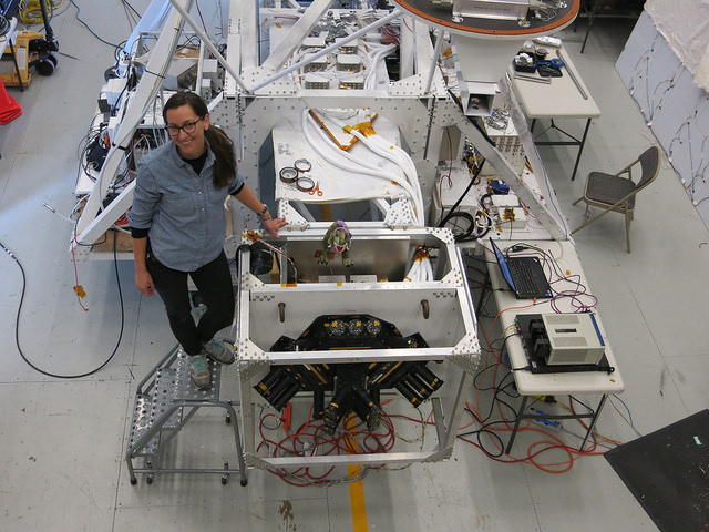 Nicole Duncan, a graduate student studying space physics at the University of California, Berkeley, stands next to the GRIPS payload. (Image Credit: NASA/University of California, Berkeley/Hazel Bain)