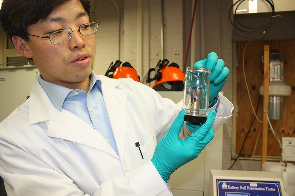 Guangsheng Zhang shows a punctured lithium-ion battery. (Image Credit: Penn State)