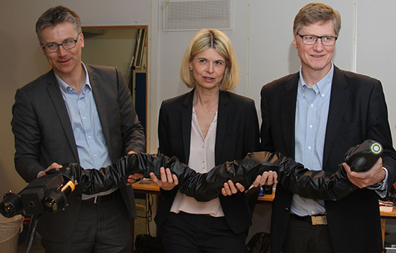 Kongsberg Maritime and Statoil executives hold one of the robotic snakes. (Image Credit: Kongsberg Maritime)