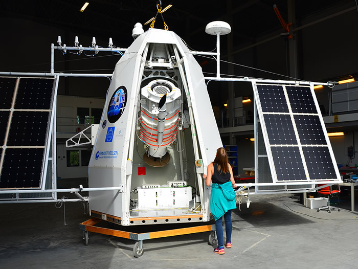 Postdoc Mette Friis examines the capsule in which is the telescope a team from KTH designed and built to study the Crab pulsar. Credit: Mark Pearce
