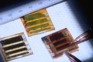 Three types of large-area solar cells made out of two-dimensional perovskites. At left, a room-temperature cast film; upper middle is a sample with the problematic band gap, and at right is the hot-cast sample with the best energy performance. Credit: Los Alamos National Laboratory.
