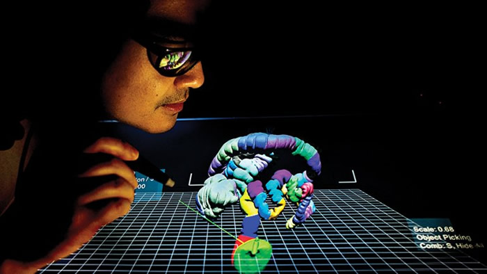 Research assistant Donald Chau demonstrates the 3-D technology that radiologist Judy Yee pioneered. Credit: Noah Berger