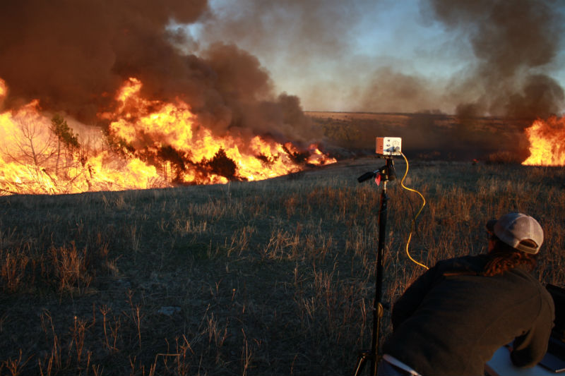 Graduate student Christina Bielski recorded data during a high intensity prescribed fire burning through juniper-invaded grassland on private property. (Image Credit: Dirac Twidwell)