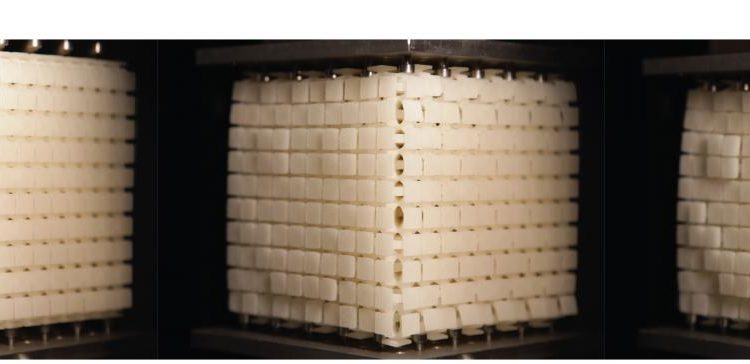To demonstrate that any pattern can be produced on a cube's surface, researchers developed a cube of 10x10x10 centimeter blocks on which a smiley face appears when the cube is compressed. (Image Credit: Corentin Coulais)