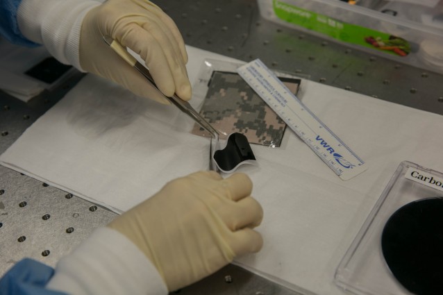 Ngoc Bui demonstrates the flexibility of a carbon nanotube membrane. (Image via LLNL)