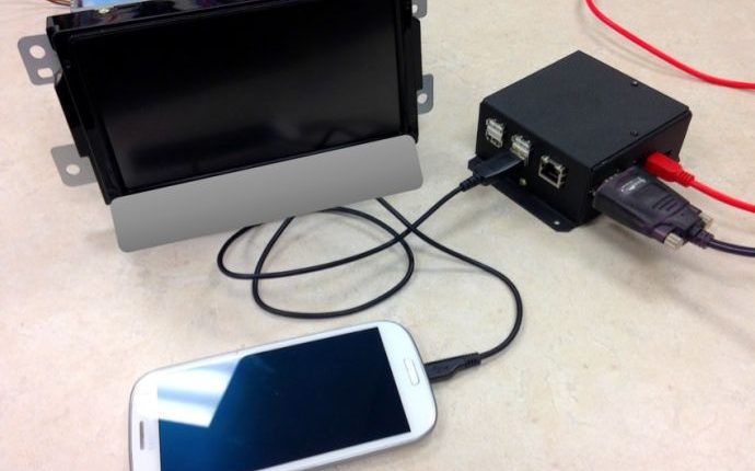 Hardware setup in which an Android phone is integrated with the head unit of a 2015 model vehicle (upper left). MirrorLink is the connection protocol and allows the driver or passenger to control phone apps via the car's dash and steering wheel controls. (Image via NYU)