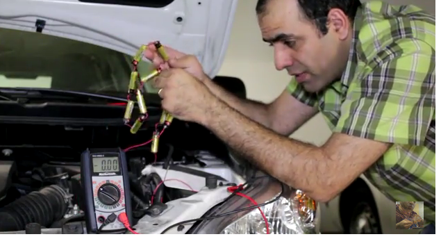 Sadaghdar jumps his car with 12 AA batteries. (Image via ElectroBOOM/YouTube)